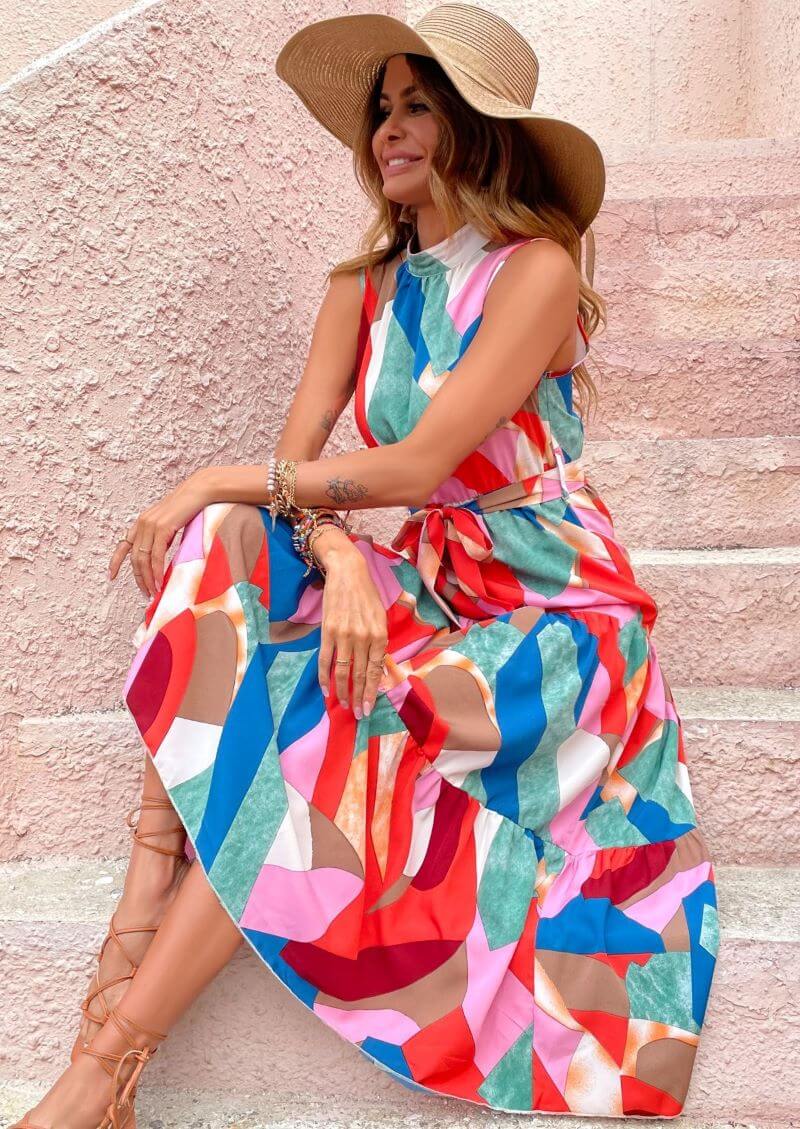 Women's summer dress- Sleeveless dress- Ankle-length- Ruffle detail- Vibrant color- Maxi dress- Summer fashion- Flowing dress- Lightweight fabric- Fashion trend- Beach wear- Casual wear- Feminine style- Bright hue- Floral design- Effortless style- Dress detail- Day dress- Versatile fashion- Bohemian style