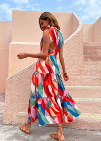 Women's summer dress- Sleeveless dress- Ankle-length- Ruffle detail- Vibrant color- Maxi dress- Summer fashion- Flowing dress- Lightweight fabric- Fashion trend-Bold patterns- Sundress- Resort wear- Warm weather fashion- Colorful dress- Dress silhouette- Chic style- Ruffled hem- Elegant dress- Cotton dress- Outdoor wear