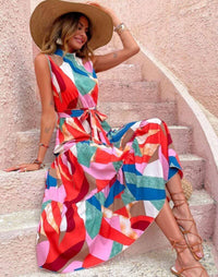 Women's summer dress- Sleeveless dress- Ankle-length- Ruffle detail- Vibrant color- Maxi dress- Summer fashion- Flowing dress- Lightweight fabric- Fashion trend- Beach wear- Casual wear- Feminine style- Bright hue- Floral design- Effortless style- Dress detail- Day dress- Versatile fashion- Bohemian style