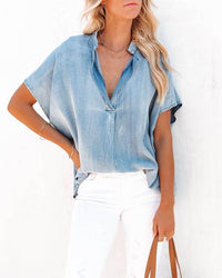 Women's oversized chambray shirt- Split neckline- Short sleeves- Soft and breathable- Cotton fabric- Relaxed fit- Casual style- Denim-like appearance- Lightweight-  Comfortable- Versatile- Easy to wear- Effortless chic- Breathable fabric