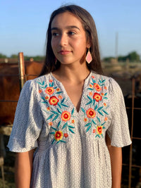 What a stunning blouse with just the ideal amount of embroidery. The floral is incredibly vibrant, and the blouse is so light and breezy! This blouse is not at all tight, it is very forgiving, and it flows beautifully!