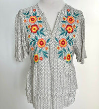 What a stunning blouse with just the ideal amount of embroidery. The floral is incredibly vibrant, and the blouse is so light and breezy! This blouse is not at all tight, it is very forgiving, and it flows beautifully!