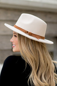 The Wide Brim Fedora with buckles detail is a fashionable, wide brimmed hat that will keep you looking classy. You can wear this in any season and it goes well with a dress or pants. The fedora is made of wool felt which provides good protection from the sun while still keeping your head cool.