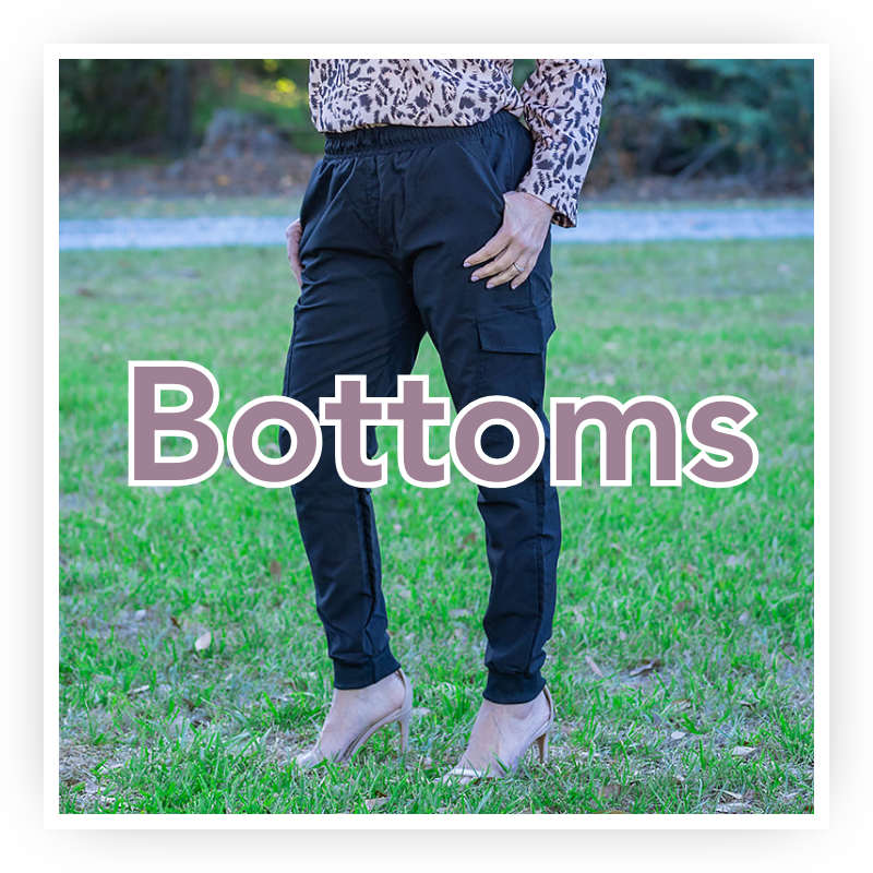 Shop Women's Bottoms | Jolie Vaughan Boutique [Image Description - a stunning 40-something year old woman wearing black chino jogger pants with the text "Bottoms" written over top.]