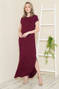 A woman wearing the Solid Short Sleeve Maxi Dress with Side Slit, styled for winter warmth and versatility.