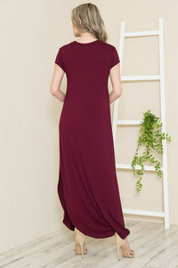 A woman wearing the Solid Short Sleeve Maxi Dress with Side Slit, styled for winter warmth and versatility.