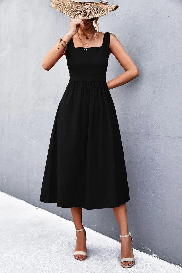 A woman wearing a Sleeveless Square-Neck Midi Dress, exuding elegance and comfort, with a contemporary square neckline and versatile wide straps.