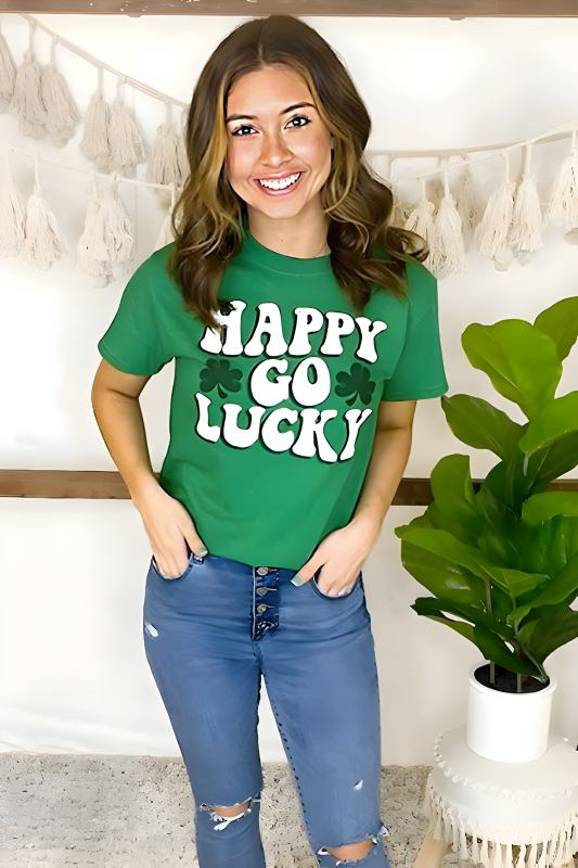 Cheerful woman in a green 'HAPPY GO LUCKY' T-shirt and distressed blue jeans for St. Patrick's Day.
