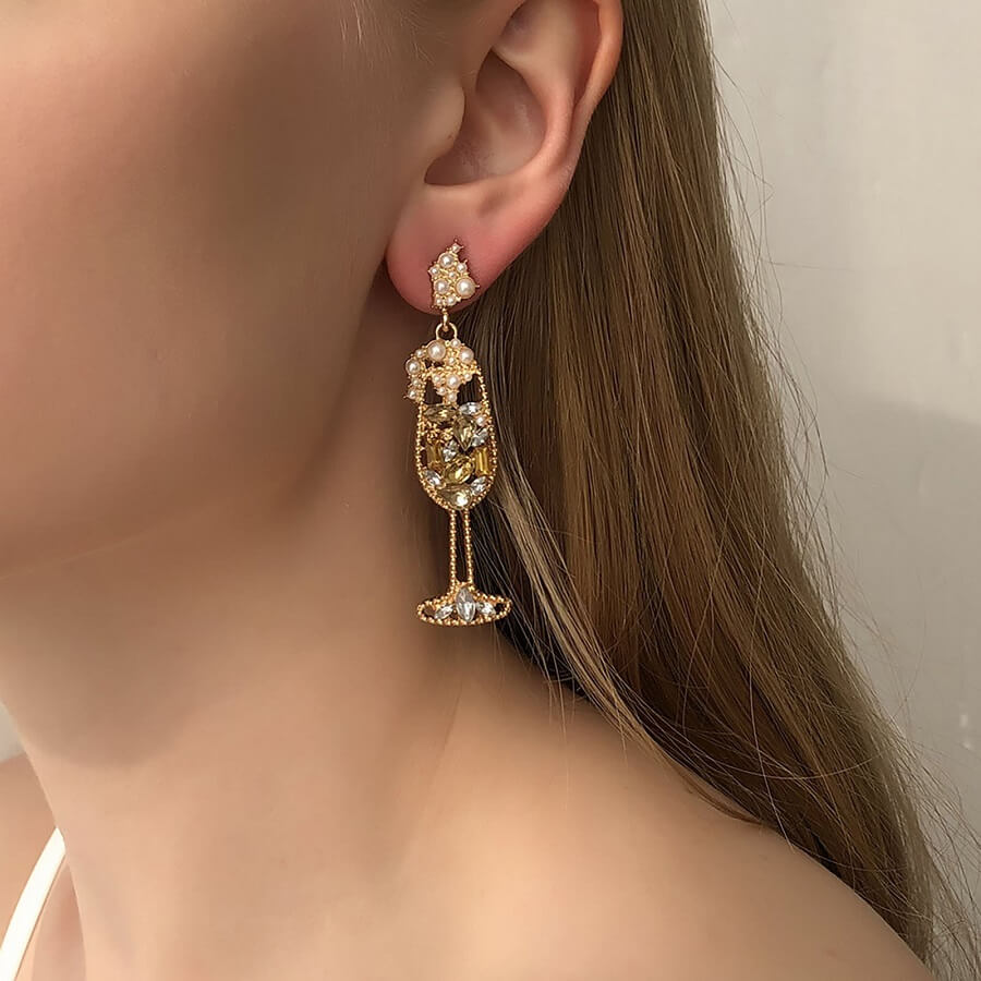 A celebration is in order - because you're you! Pop the bubbly and enjoy this luxe lobe treat (alongside your favorite glass). This pair of champagne glass statement earrings is perfect for every single special event or party.